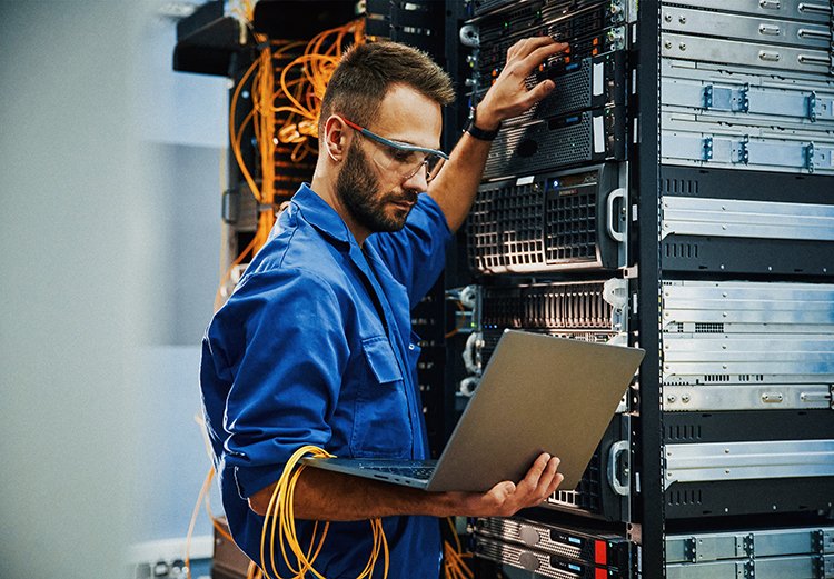 A man performs maintenance in a data center.