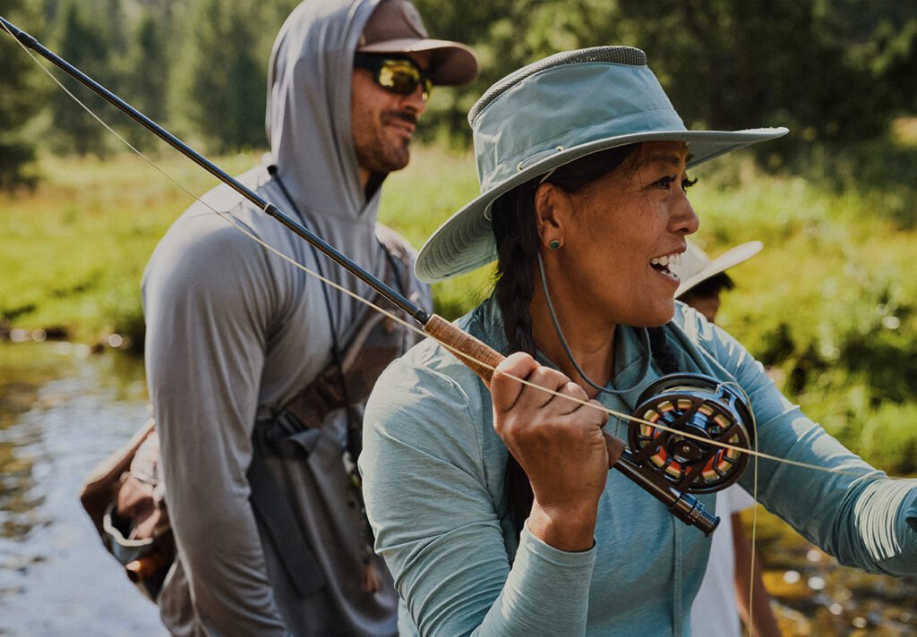 A man and woman are fly fishing.